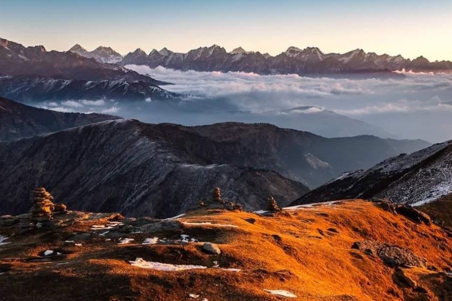 Sunrise view over Himalayan peaks rising above cloud layer